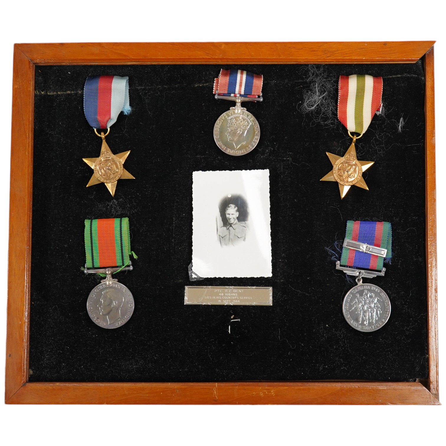 A group of five framed medals including the 1939 to 1945 Canada voluntary service medal, awarded to Private R.E. Bent, 48 Highlanders. Condition - fair to good